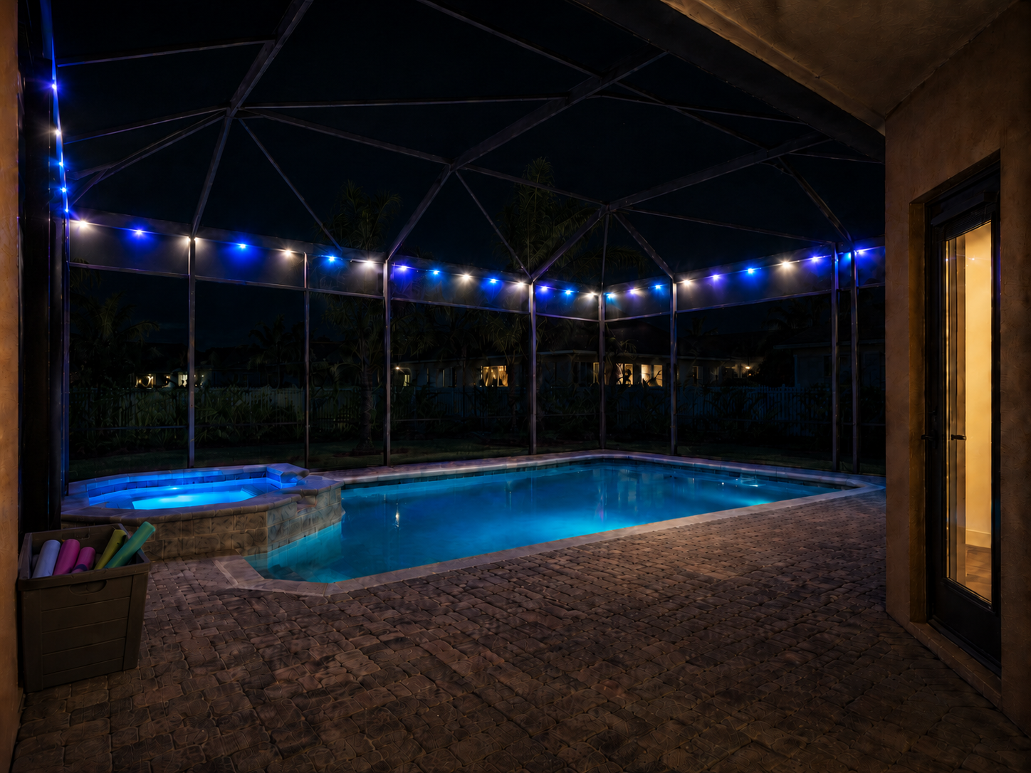 Pool cage lit with blue and white LED lighting at night