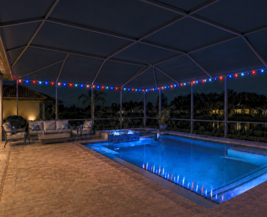 Screened pool enclosure with red, white, and blue LED cage lighting